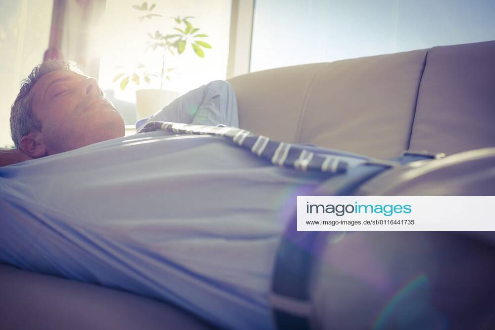 Businessman relaxing on a couch Businessman relaxing on a couch in living room, model released, Cape Town, South Africa, 17.03.2015, 527891.jpg, business, businessman, classy, corporate, elegant, executive, professional, sophisticated, stylish, well dressed, sofa, couch, living room, house, home, sitting room, suit, relaxation, lying, napping, resting, sleeping, bright, eyes closed, sun, light, blinding, filter 30s, Mid Adult, Man, Male, Caucasian, 35-39 Years, Mid Adult Men, Caucasian Ethnicity Indoors,Day