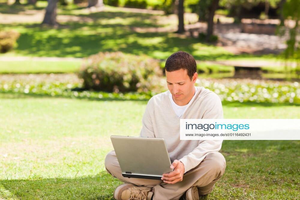 Man working on his laptop in the park Man working on his laptop in the park during the summer, model released, Cape Town, South Africa, 16.11.2010, 59515.jpg, attractive, carefree, garden, green, greenery, handsome, happiness, happy, leisure, lifestyle, outdoor, outside, park, relax, relaxation, smile, summer, smiling, tree, sit, sitting, pose, posing, looking, technology, communication, laptop, notebook, internet, using, working 30s, Mid Adult, Man, Male, Caucasian, Caucasian Appearance, 30-34 Years, Mid Adult Men Outdoors