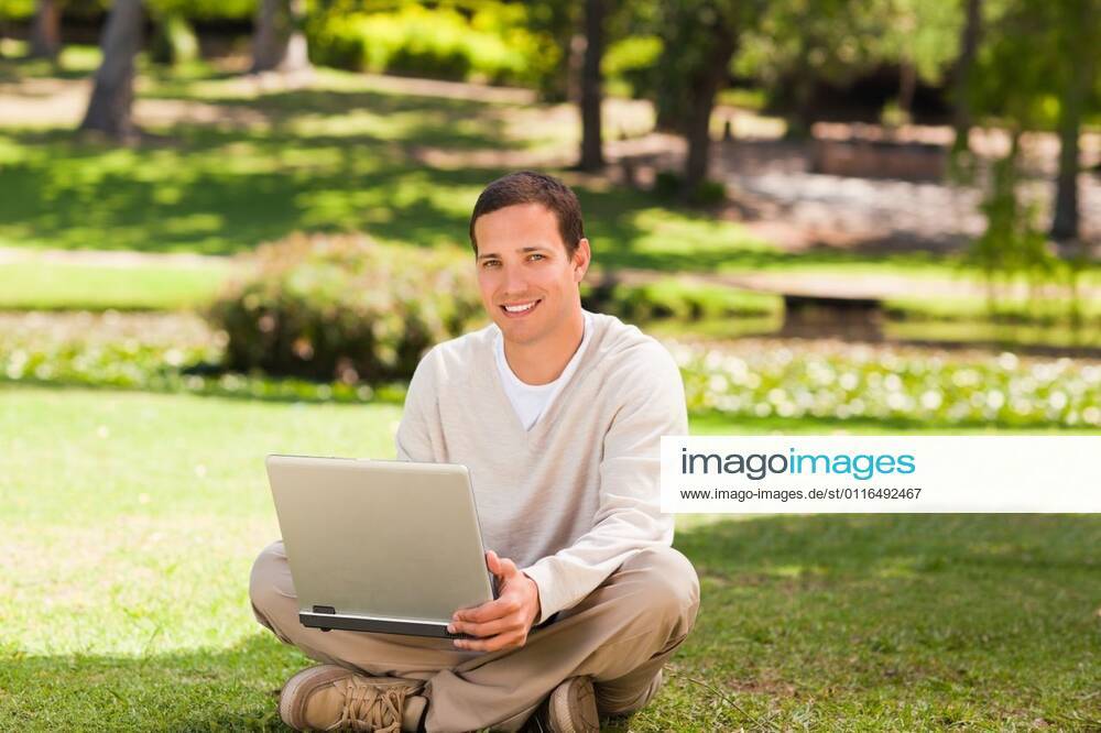Man working on his laptop in the park Man working on his laptop in the park during the summer, model released, Cape Town, South Africa, 16.11.2010, 59517.jpg, attractive, carefree, garden, green, greenery, handsome, happiness, happy, leisure, lifestyle, outdoor, outside, park, relax, relaxation, smile, summer, smiling, tree, sit, sitting, pose, posing, looking, technology, communication, laptop, notebook, internet, using, working 30s, Mid Adult, Man, Male, Caucasian, Caucasian Appearance, 30-34 Years, Mid Adult Men Outdoors