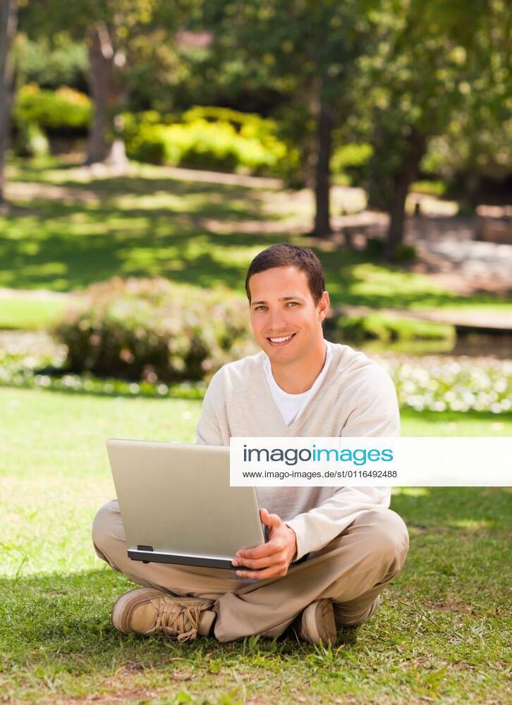 Man working on his laptop in the park Man working on his laptop in the park during the summer, model released, Cape Town, South Africa, 16.11.2010, 59519.jpg, attractive, carefree, garden, green, greenery, handsome, happiness, happy, leisure, lifestyle, outdoor, outside, park, relax, relaxation, smile, summer, smiling, tree, sit, sitting, pose, posing, looking, technology, communication, laptop, notebook, internet, using, working 30s, Mid Adult, Man, Male, Caucasian, Caucasian Appearance, 30-34 Years, Mid Adult Men Outdoors