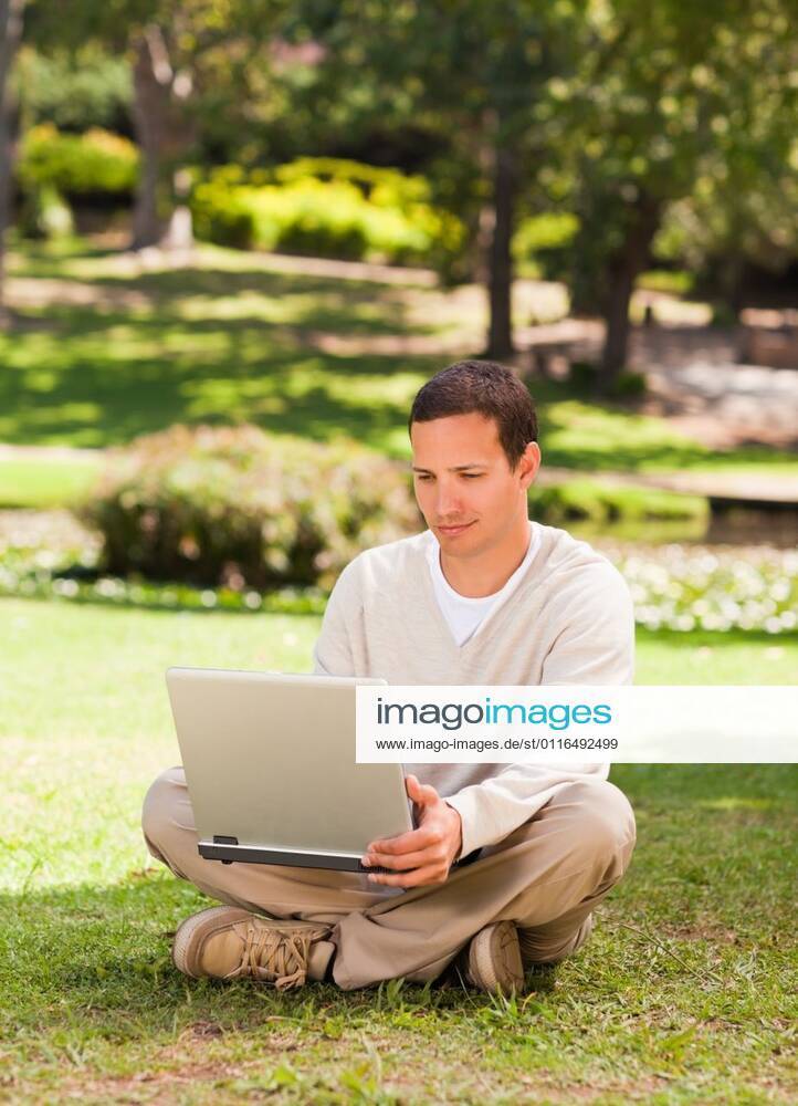 Man working on his laptop in the park Man working on his laptop in the park during the summer, model released, Cape Town, South Africa, 16.11.2010, 59520.jpg, attractive, carefree, garden, green, greenery, handsome, happiness, happy, leisure, lifestyle, outdoor, outside, park, relax, relaxation, smile, summer, smiling, tree, sit, sitting, pose, posing, looking, technology, communication, laptop, notebook, internet, using, working 30s, Mid Adult, Man, Male, Caucasian, Caucasian Appearance, 30-34 Years, Mid Adult Men Outdoors