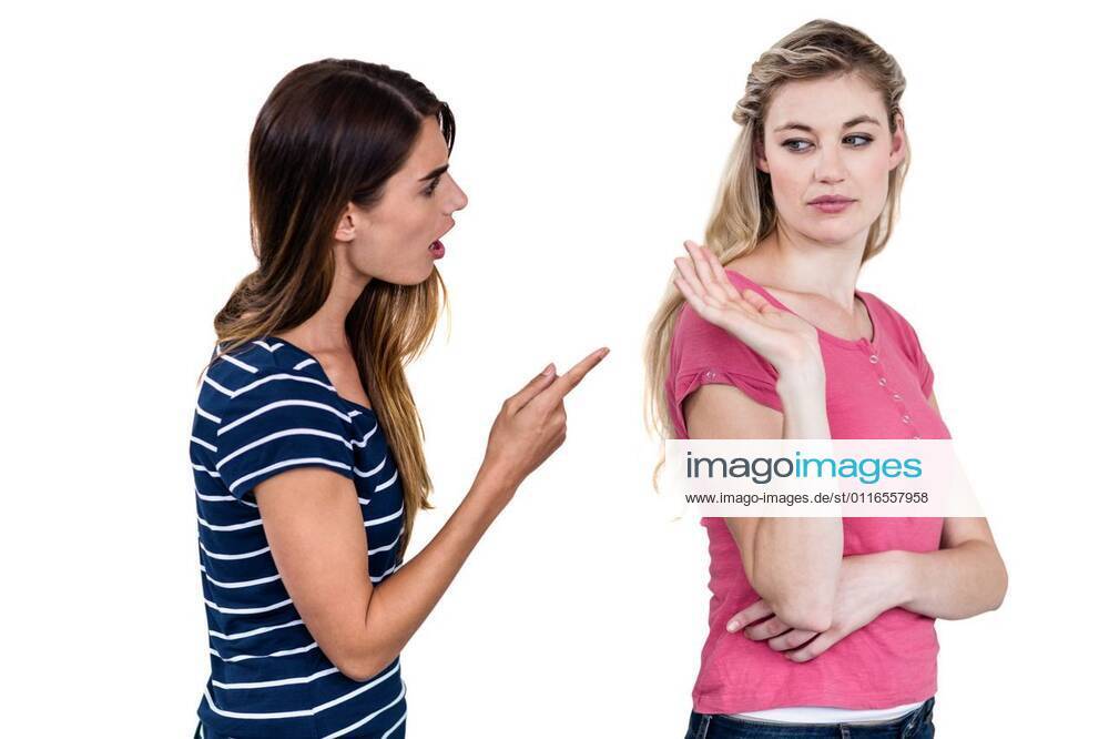 Female friends arguing Female friends arguing while standing over white background, model released, Cape Town, South Africa, 20.11.2015, 684916.jpg, casual clothing, pointing, friend, friendship, standing, isolated, cut out, annoyed, argument, fight, distant, angry, irritated, problems, troubles, unhappy, upset, serious, stern, unsmiling, frowning, dispute, disagreement, quarreling, fighting, relationship difficulties, arguing 20s, Young Adult, Woman, Female, Caucasian, 20-24 Years, Young Women, Caucasian Ethnicity Studio shot,Three Quarter Length,White background