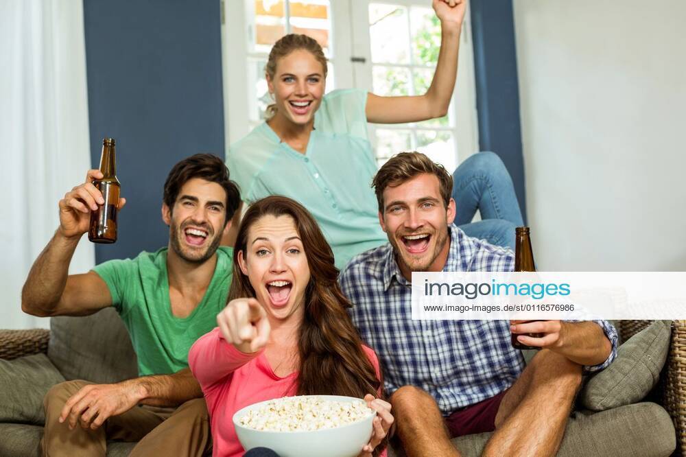 Portrait of smiling friends enjoying party Portrait of smiling happy friends enjoying party at home, model released, , property released, Cape Town, South Africa, 08.12.2015, 706145.jpg, beautiful, lifestyle, leisure, sitting, pretty, attractive, looking, beautiful woman, home, homey, household, apartment, domicile, casual clothing, relaxing, beauty, house, abode, friends, friendship, causal, togetherness, living room, sitting room, handsome, smart, enjoying, arms raised, bowl, food, drink, bottle, holding, refreshment, beer, casual, couch, fun, group, laughing, party, screaming, shouting, smiling, sofa, alcohol, door, happiness, cheerful, joyful Indoors,Front view,Portrait,Looking at camera,Day,Three Quarter Length