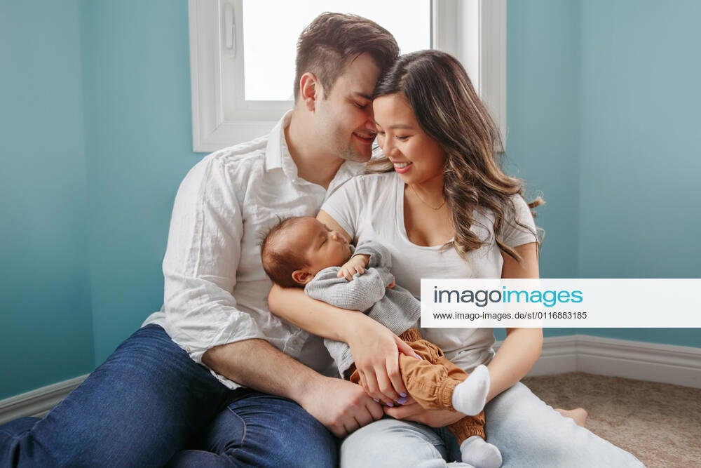Young family with newborn baby boy at home. Happy parents with kid Toronto, ON, Canada CR_EHILXN210419A-714069-01 ,model released, Symbolfoto