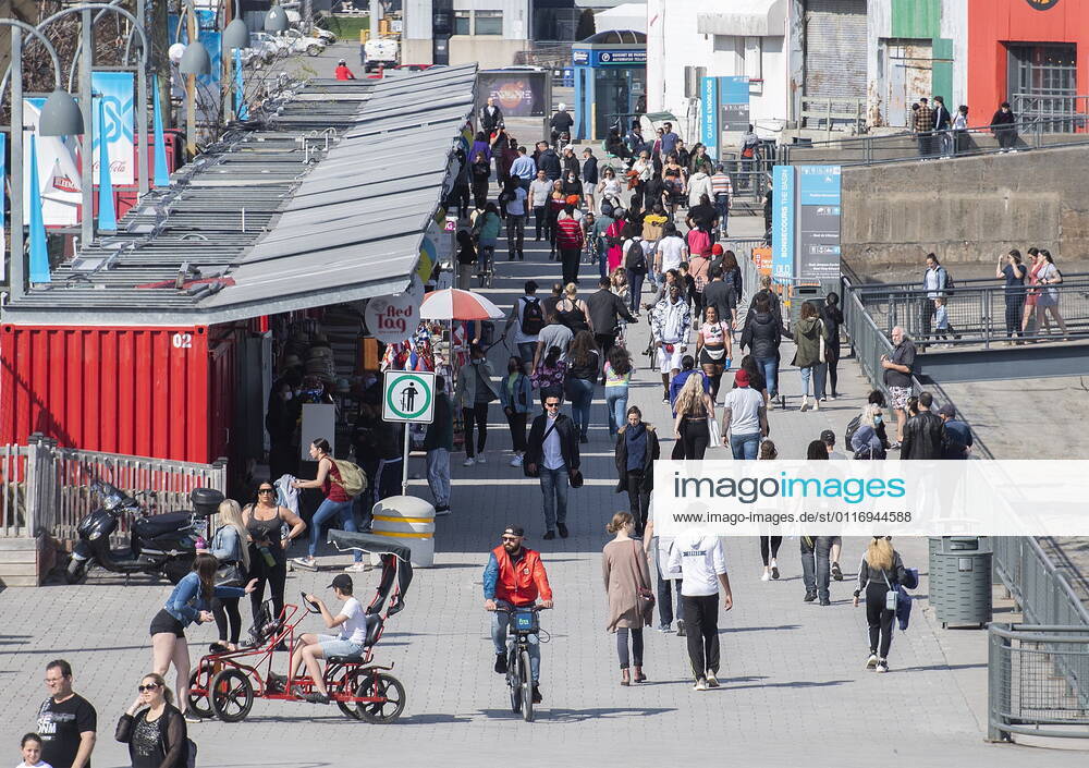 People walk in the Old Port on a warm spring day in Montreal, Saturday, April 24, 2021, as the COVID-19 pandemic continues in Canada and around the world. Montreal Canada - ZUMAc35_ 20210424_zaf_c35_039