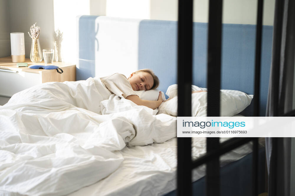 Woman sleeping in bed at home model released Symbolfoto property released VPIF03730