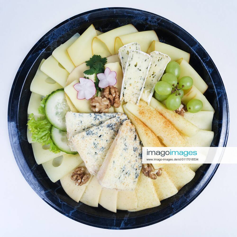 Kaeseplatte mit verschiedenen Kaesesorten und Garnierung cheese platter BLWS643282