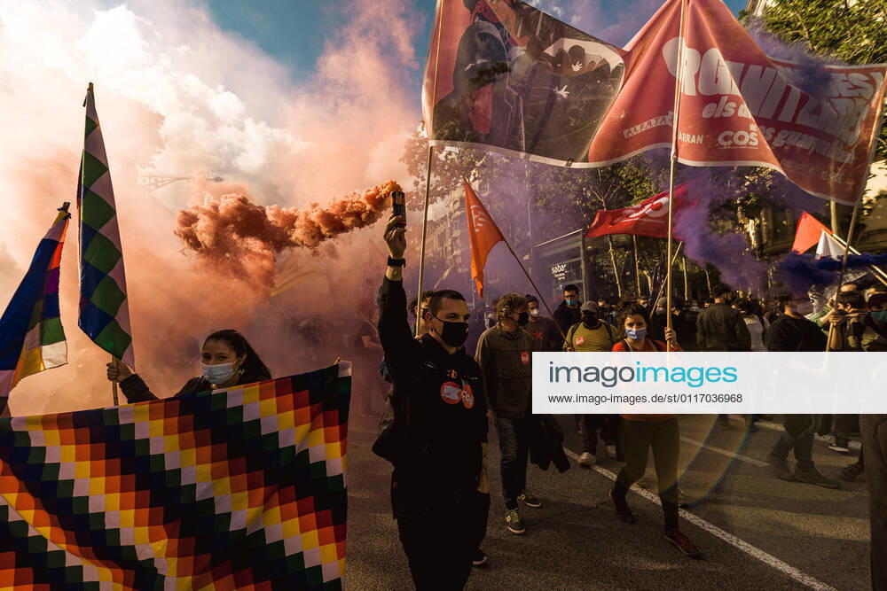 A protester holds a Bengal flare as members of a great variety of left-wing groups march through the center of Barcelona marking May 1st Barcelona Spain - ZUMAo105 20210501_zap_o105_011
