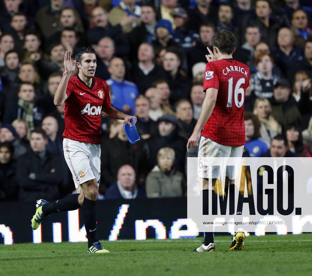 Manchester United s Robin Van Persie celebrates his sides third goal with part of a seat thrown on the pitch -- Chelsea FC London vs. Manchester United (ManU) - Barclays Premier League - Stamford Bridge, London- 28 10 12 - Klein Sportimage .
