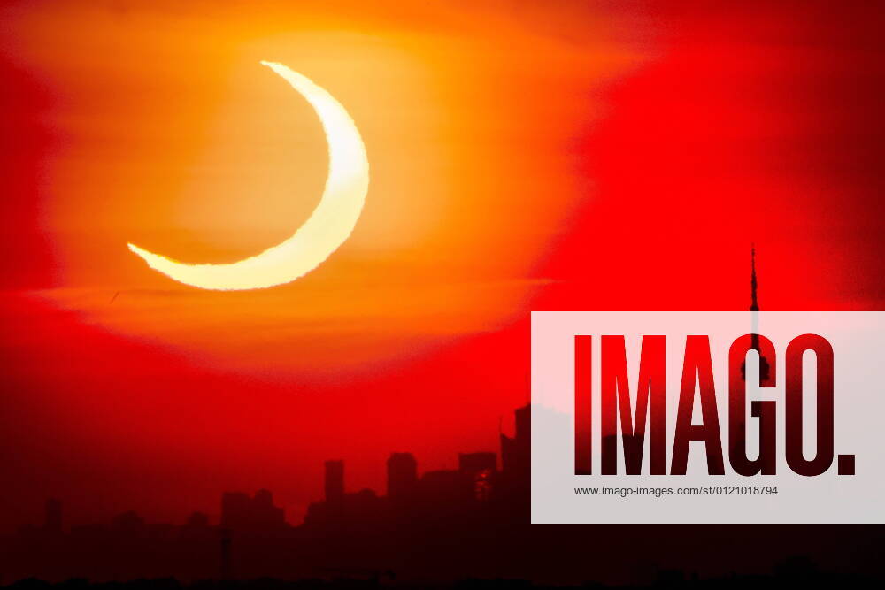 An annular solar eclipse rises over the skyline of Toronto on Thursday. Toronto Canada - ZUMAc35_ 20210610_zaf_c35_004