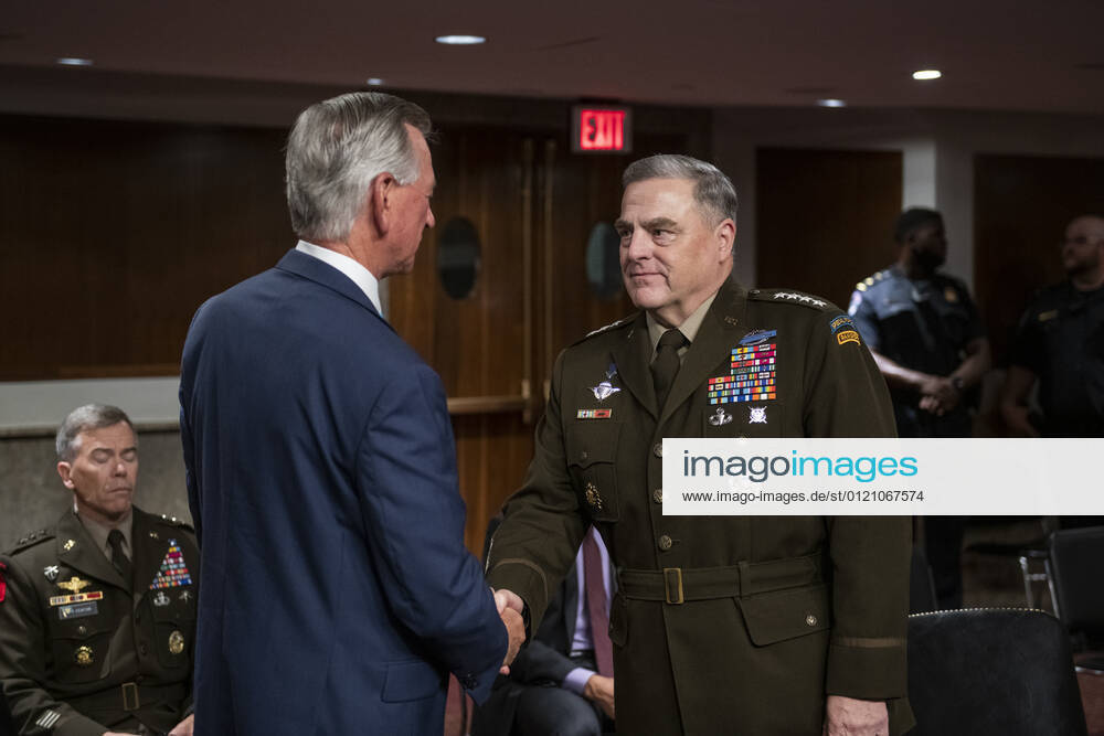 General Mark Milley, Chairman of the Joint Chiefs of Staff, right, is greeted by United States Senator Tommy Tuberville (Republican of Alabama), left, as he appears at a Senate Committee on Armed Services hearing to examine the Department of Defense budget posture in review of the Defense Authorization Request for fiscal year 2022, in the Dirksen Senate Office Building in Washington, DC, Thursday