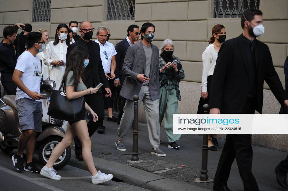 Milan, Adrien Brody at the Armani fashion show The American actor and producer ADRIEN BRODY leaves the Armani hotel, and accompanied by Roberta Armani walks towards the Armani maison where the fashion show will take place.