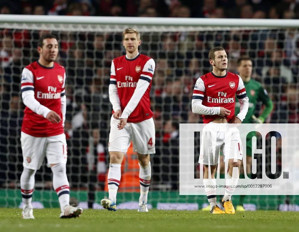 Arsenal s Jack Wilshere looks on dejected after going 2-0 down. On the left Per Mertesacker. FC Arsenal London vs. Manchester City - Barclays Premier League - Emirates Stadium, London- 13 01 13 .