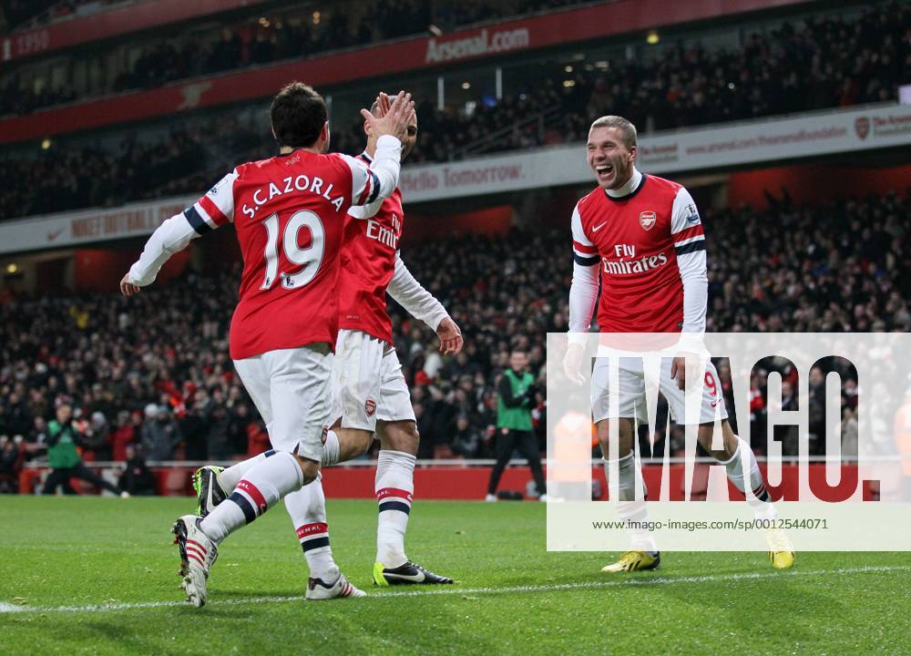 Arsenal s Lukas Podolski celebrates setting up his sides third goal..Arsenal v West Ham United - Barclays Premier League - the Emirates Stadium, London- 23 01 13 - Picture David Klein Sportimage .