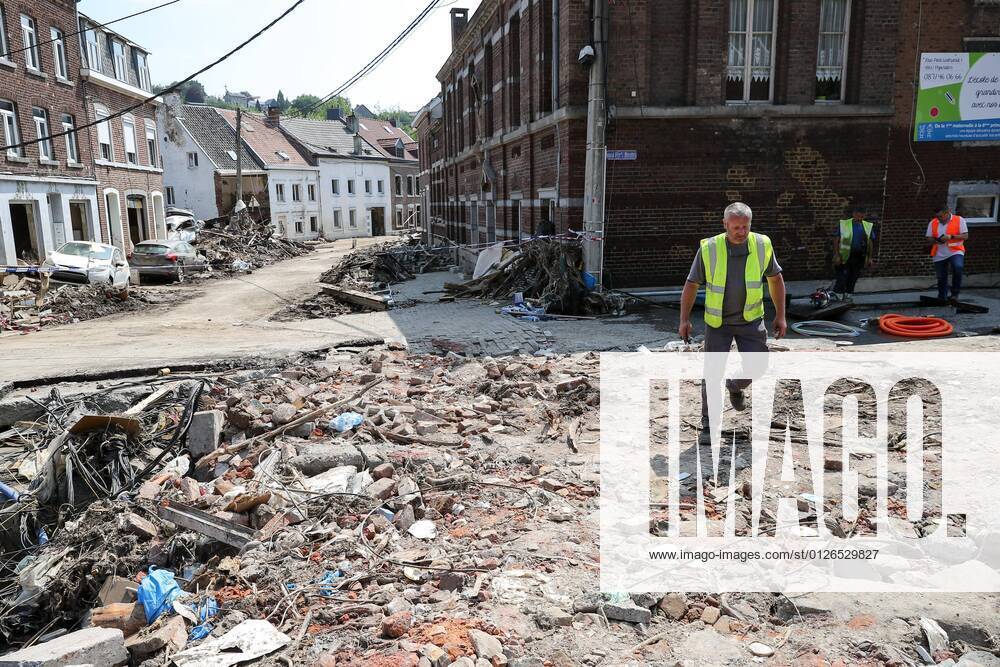(210721) -- PEPINSTER, July 21, 2021 -- A staff member walks on a damaged road in Pepinster, Belgium, July 20, 2021. Belgium is affected by floods and clean-up is under way to help the hard-hit regions recover from the destructions. ) BELGIUM-PEPINSTER-FLOODS-AFTERMATH ZhangxCheng