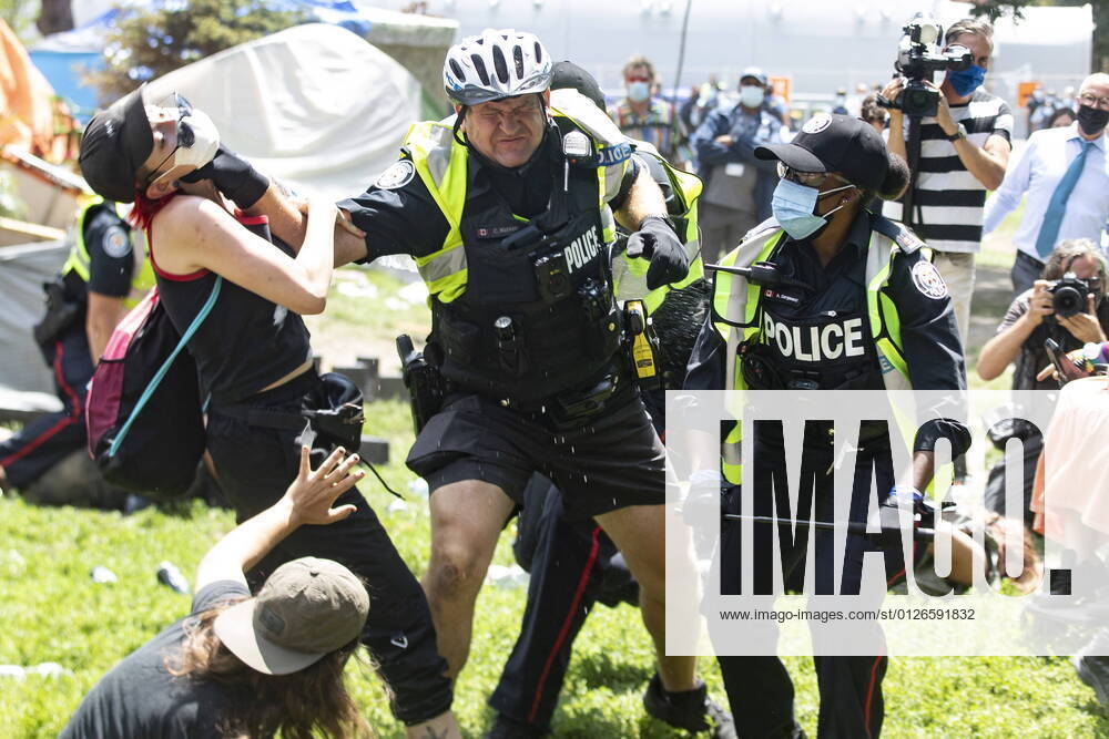 Police remove encampment supporters as they clear Lamport Stadium Park encampment in Toronto on Wednesday July 21, 2021. The operation came a day after a different encampment was cleared at a downtown park. The city has cited the risk of fires and the need to make parks accessible to everyone as factors behind the clearings. Toronto Canada - ZUMAc35_ 20210721_zaf_c35_019