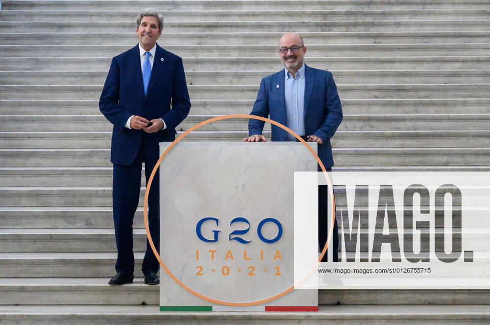 John Kerry (L), US Special Presidential Envoy for Climate, and Italian Minister for Ecological Transition Roberto Cingolani (R) pose for photographs behind the G20 logo..Italian Minister of the Ecological Transition Roberto Cingolani chaired the G20 Environment, Climate and Energy Joint Ministerial Meeting, on the second day in Naples, organized within the framework of the Italian Presidency of the G20. The meeting, held at the Royal Palace, had seen the participation of keynote speakers coming from the G20 countries and several international institutions and organizations. Napoli Italy - ZUMAs197 20210723_zaa_s197_282