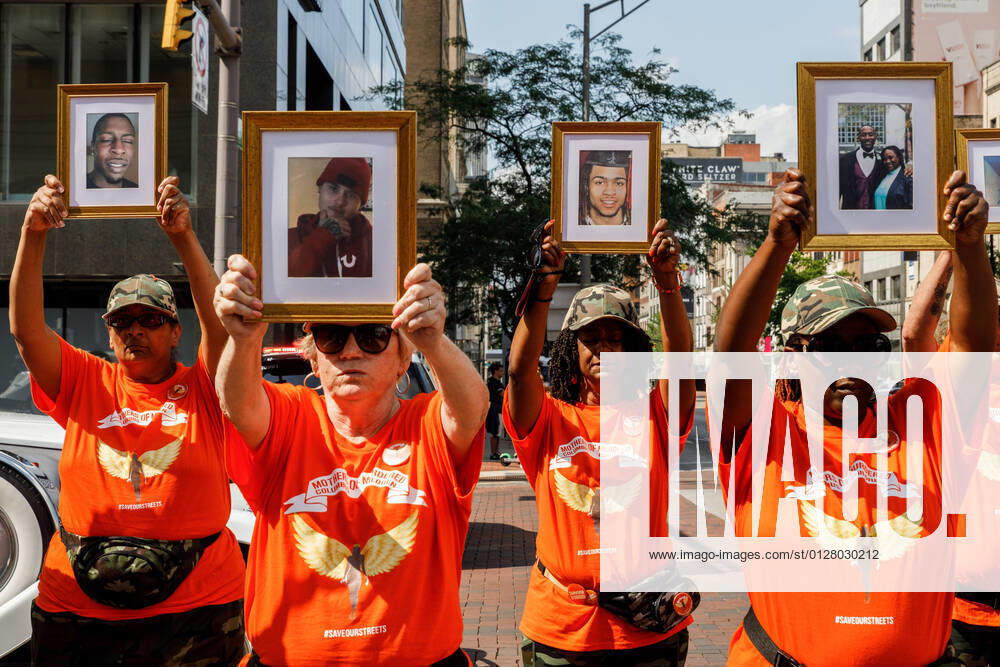 Mothers of Murdered Columbus Children stand at the intersection of High Street and Broad Street while holding pictures of their deceased children..In reaction to the rising violence since 2020 Malissa Thomas-St. Clair, a mother of a murdered son, Anthony Thomas-St. Clair, founded Mothers of Murdered Columbus Children (MOMCC), an anti-violence group seeking to end violent crime in Columbus, Ohio. MOMCC led the effort for a Central Ohio Anti-Violence March & Rally at City Hall featuring many other mothers who lost children to violence, the Ceasefire initiative led by Al Edmondson and many other community and governmental leaders. The rally and March started off with many speakers, concluding a ma - ZUMAs197 20210801_zaa_s197_213