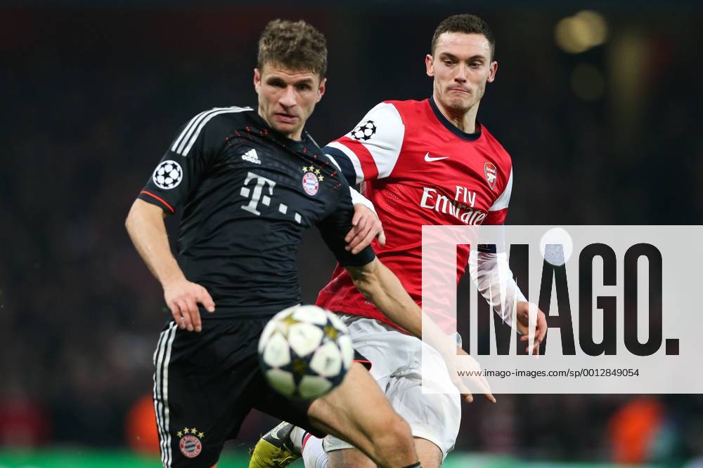 Football - 2012 2013 Champions League - Round of 16, First Leg: Arsenal vs. Bayern Munich Bayern Munich s Thomas Müller and Thomas Vermaelen of Arsenal at the Emirates Stadium, London