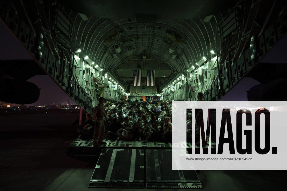 Kabul, Afghanistan - A aircrew, assigned to the 816th Expeditionary Airlift Squadron, assists qualified evacuees aboard a C-17 Globemaster III aircraft in support of the Afghanistan evacuation at Hamid Karzai International Airport, Afghanistan, Aug. 21, 2021. The Department of Defense is committed to supporting the U.S. State Department in the departure of U.S. and allied civilian personnel from Afghanistan and to evacuate Afghan allies to safety. ( Senior Airman Taylor Crul) Kabul Afghanistan - ZUMAz03_ 20210821_szp_z03_929