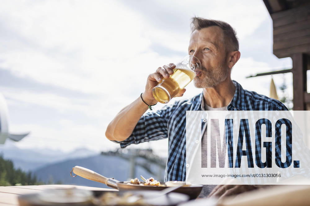 Man drinking beer while sitting at restaurant model released Symbolfoto DIGF16315