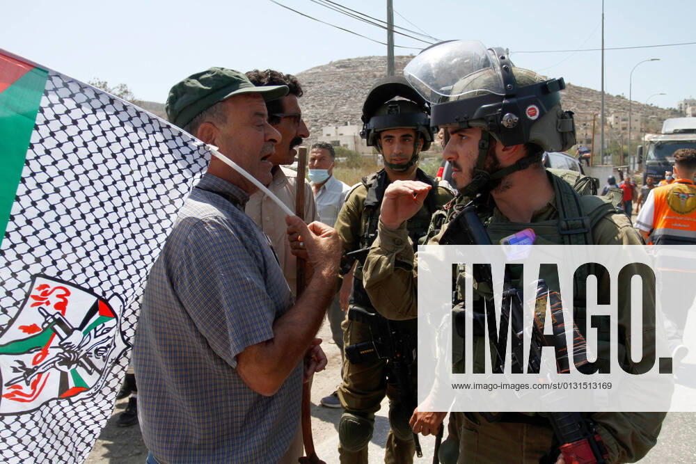 Protesters chant slogans while confronting Israeli soldiers during the demonstration..Palestinians protest against the construction of a new road for Israeli settlers, and also call for the removal of the Israeli outpost Eviatar near Beita, south of Nablus in the West Bank. Nablus Palestine - ZUMAs197 20210825_zaa_s197_106