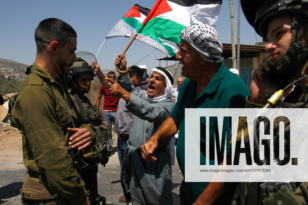 Protesters chant slogans while confronting Israeli soldiers during the demonstration..Palestinians protest against the construction of a new road for Israeli settlers, and also call for the removal of the Israeli outpost Eviatar near Beita, south of Nablus in the West Bank. Nablus Palestine - ZUMAs197 20210825_zaa_s197_107