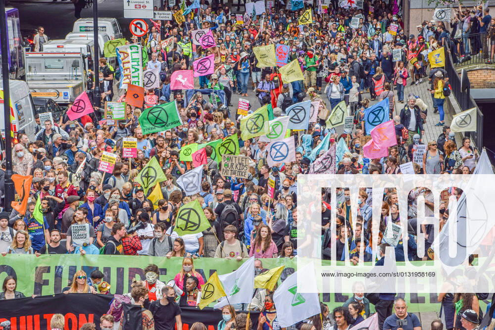 Protesters march with Extinction Rebellion flags and banners during the demonstration in London Wall..Extinction Rebellion protesters staged the Blood Money March, part of their two-week Impossible Rebellion campaign, targeting the City of London, the capital s financial hub. London United Kingdom - ZUMAs197 20210827_zaa_s197_182