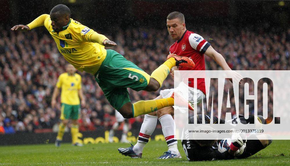 - Lukas Podolski (Top, R) of Arsenal attacks as Sebastien Bassong of Norwich (Top, L) and his goalie Mark Bunn save the ball during their Barclays Premier League match at the Emirates Stadium in London, Britain, on April 13, 2013. Arsenal won 3-1. (Xinhua Wang Lili)