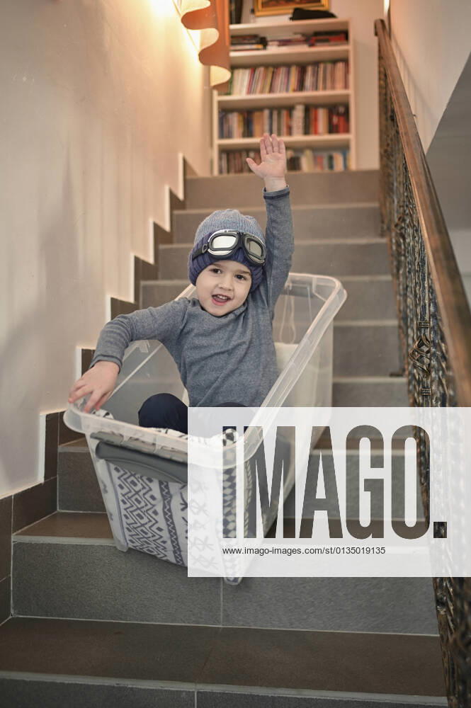IMAGO Creative: Jahreszeit Winter, Fantasievoll drinnen spielen junge,schlitten fahren,treppenstufen,jungen,rodeln,schlittenfahren,stufe,stufen,treppenstufe