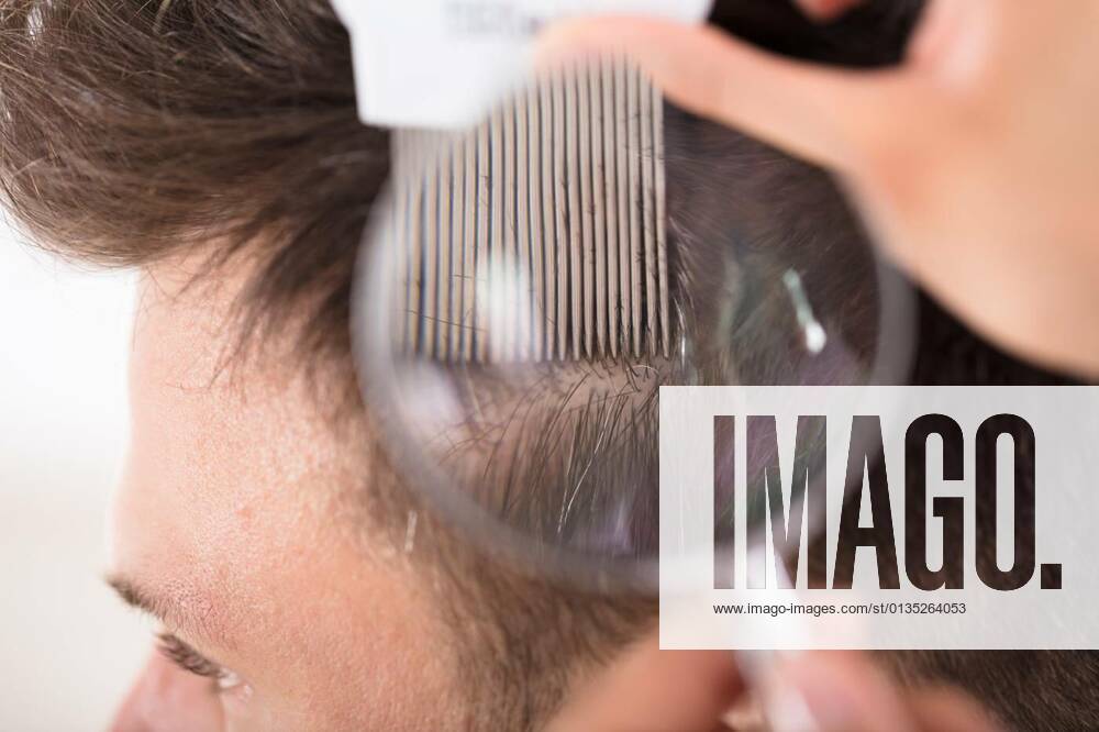 Dermatologist With Magnifier Examining Patient model released, Symbolfoto, 12.10.2020,