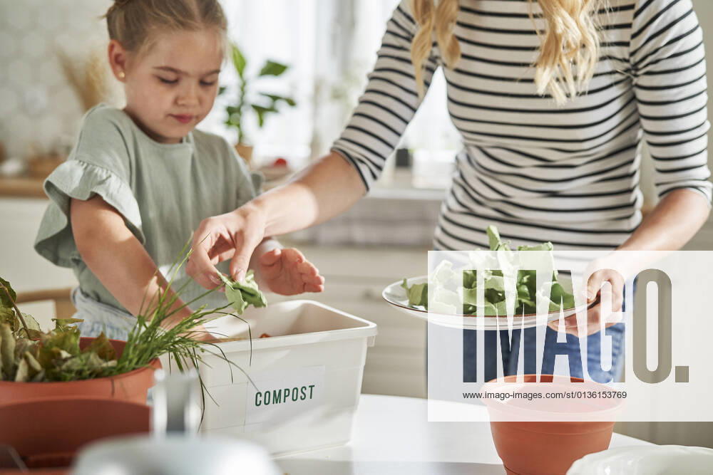 Mother and daughter making compost at home model released Symbolfoto property released ABIF01610