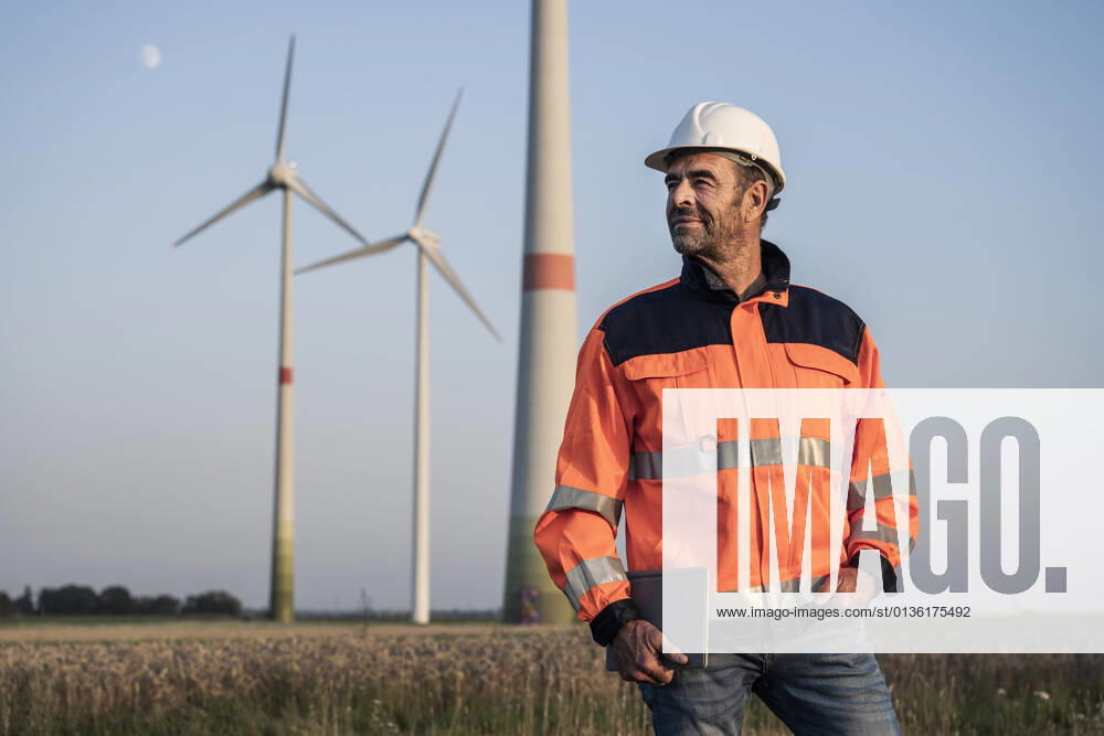 IMAGO Creative: 2021 Favoriten IMAGO Creative: Corporate: Klimaschutz, Digitalisierung und Urbanisierung IMAGO Creative: Klimawandel - Zukunft und Innovation Male inspector in reflective clothing holding digital tablet at meadow model released Symbolfoto UUF24597