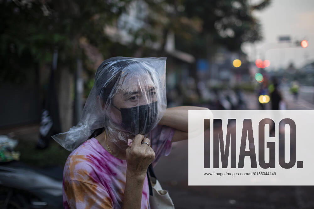 A woman wears a bag over her head to protect against residual particles from the water cannon, that can still cause intense burning in the eyes and throat, during a pro-democracy rally in Bangkok, Thailand, Wednesday, September 29, 2021. The protest remained peaceful until met with police resistance that saw the use of a potent mix of chemicals from water cannons similar to the effects of tear gas or pepper spray, while protestors through plastic bags filled with paint and some small, homemade explosives. Bangkok Thailand - ZUMAm249 20210929_zip_m249_016