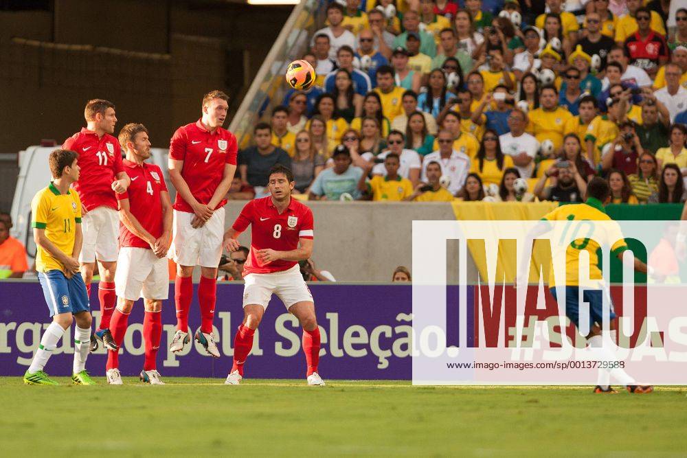 Football - International Friendly - Brazil vs. England Neymar of Brazil sends a free kick around the England wall at the Maracana Stadium, Rio de Janeiro