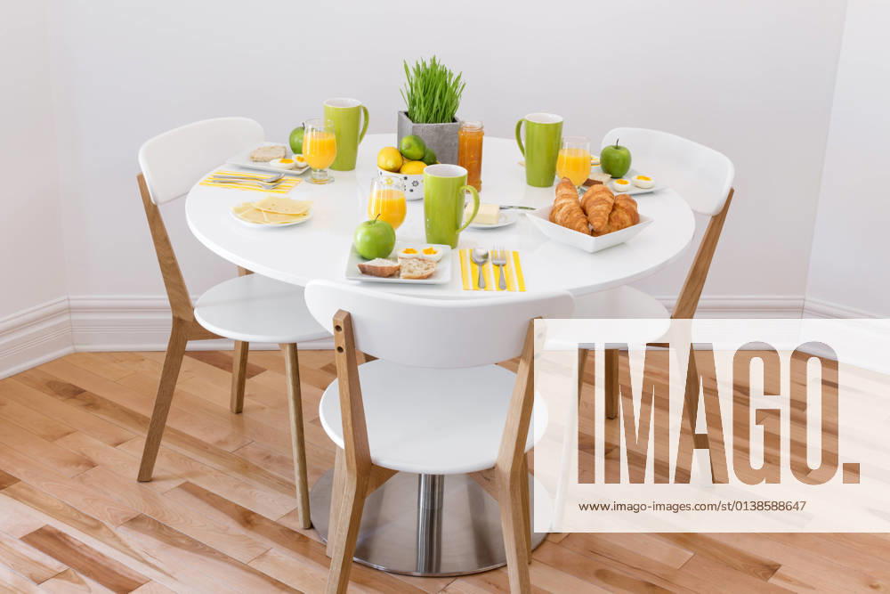 Elegant round table with tasty breakfast for three.