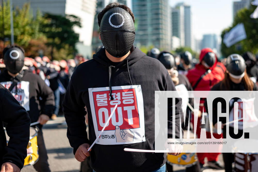 General Strike Of The Korean Confederation Of Trade Unions In Seoul A member of the Korean Confederation of Trade Unions wears mask costumed in the Netflix series Squid Game for a march to Seoul City hall during a rally against the government s labor policy on October 20, 2021 in Seoul, South Korea. Thousands of union members hold a massive rally in Seoul as an one-day strike aimed at bringing labor issues to the next presidential election in 2022. Seoul South Korea