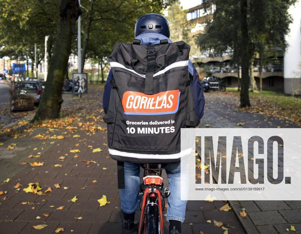 AMSTERDAM - A flash deliverer of gorillas en route in Amsterdam. ANP RAMON VAN FLYMEN