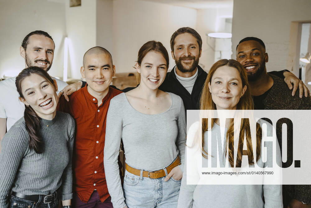 Portrait of happy multiracial male and female hackers in startup company Germany, Berlin, model released, property released