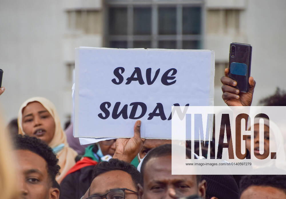 A protester holds a Save Sudan placard during the demonstration. .Large crowds gathered outside Downing Street in protest against the military coup in Sudan and demanded a return to civilian rule. London United Kingdom - ZUMAs197 20211030_zaa_s197_222