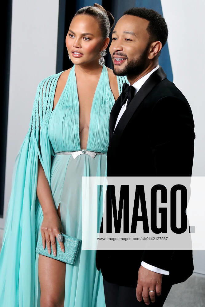 2020 Vanity Fair Oscar Party Model Chrissy Teigen wearing a Georges Hobeika ?dress, Giuseppe Zanotti heels, Heliopolis clutch and Lorraine Schwartz jewelry and husband singer John Legend arrive at the 2020 Vanity Fair Oscar Party held at the Wallis Annenberg Center for the Performing Arts on February 9, 2020 in Beverly Hills, Los Angeles, California, United States. Beverly Hills California United States