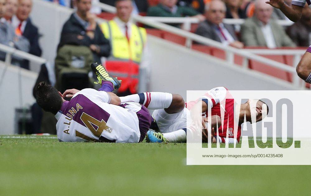 Arsenal s Alex Oxlade-Chamberlain gets caught late by Villa s Antonio Luna and goes off imjured - FC Arsenal London v Aston Villa FC - Barclays Premiership - Emirates Stadium - London - England -17 08 2013 - .