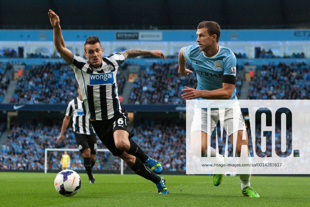 Edin Dzeko of Manchester City breaks past Hatem Ben Arfa of Newcastle United - Manchester City vs. Newcastle United - Premier League - Etihad Stadium - Manchester - 19 08 2013 Pic Philip Oldham Sportimage .