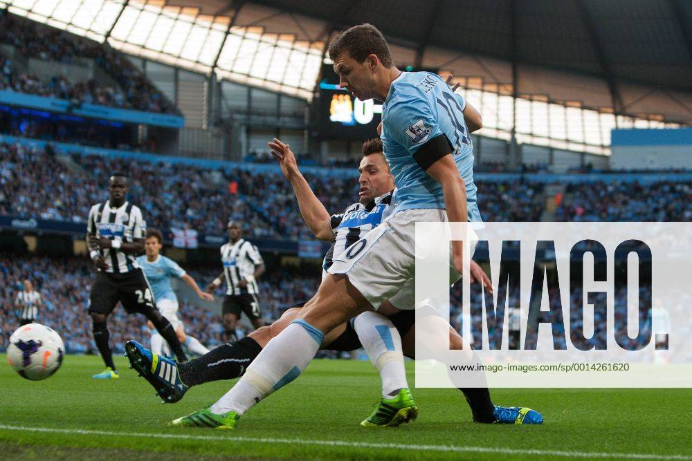 Edin Dzeko of Manchester City breaks past Hatem Ben Arfa of Newcastle United - Manchester City vs. Newcastle United - Premier League - Etihad Stadium - Manchester - 19 08 2013 Pic Philip Oldham Sportimage .