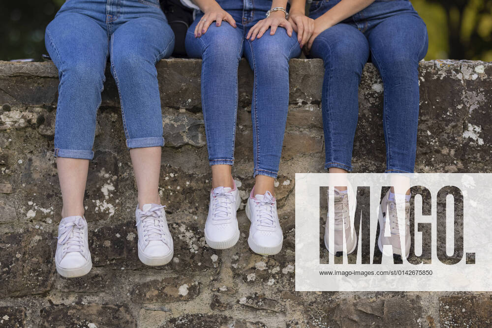 Female friends sitting on retaining wall model released, JPF00440