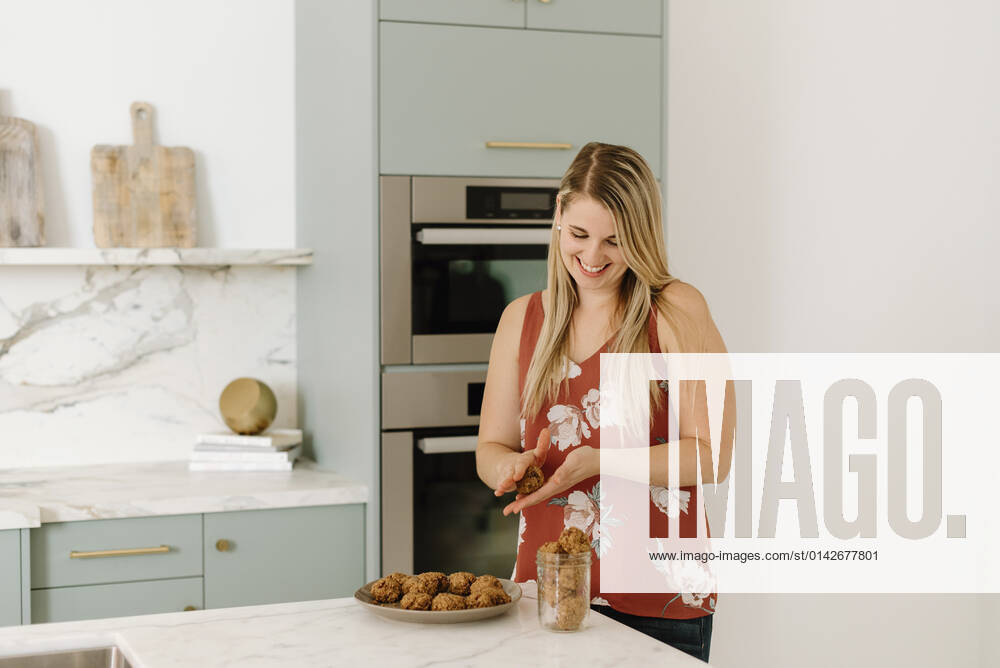 Female nutritionist preparing food at kitchen counter model released property released, SMSF00569