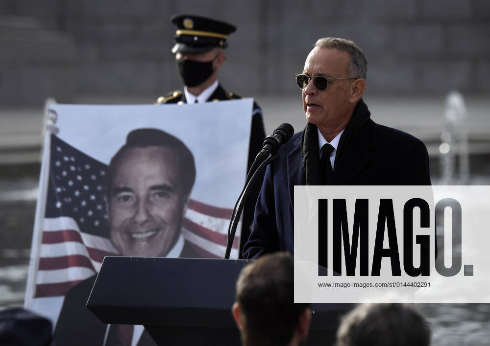 TOM HANKS speaks as mourners pay respects to the late Senator Bob Dole (R-KS) as the hearse makes a stop at a ceremony at the World War II Memorial in Washington DC on December 10, 2021. Washington USA - ZUMAg208 20211210_zap_g208_050