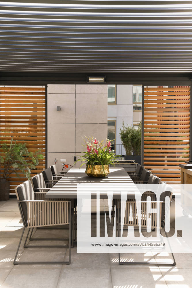 Exterior of spacious modern terrace with dining table with chairs placed near grill under roof CasaMedia_FredRoeskestraat88A9_57.jpg