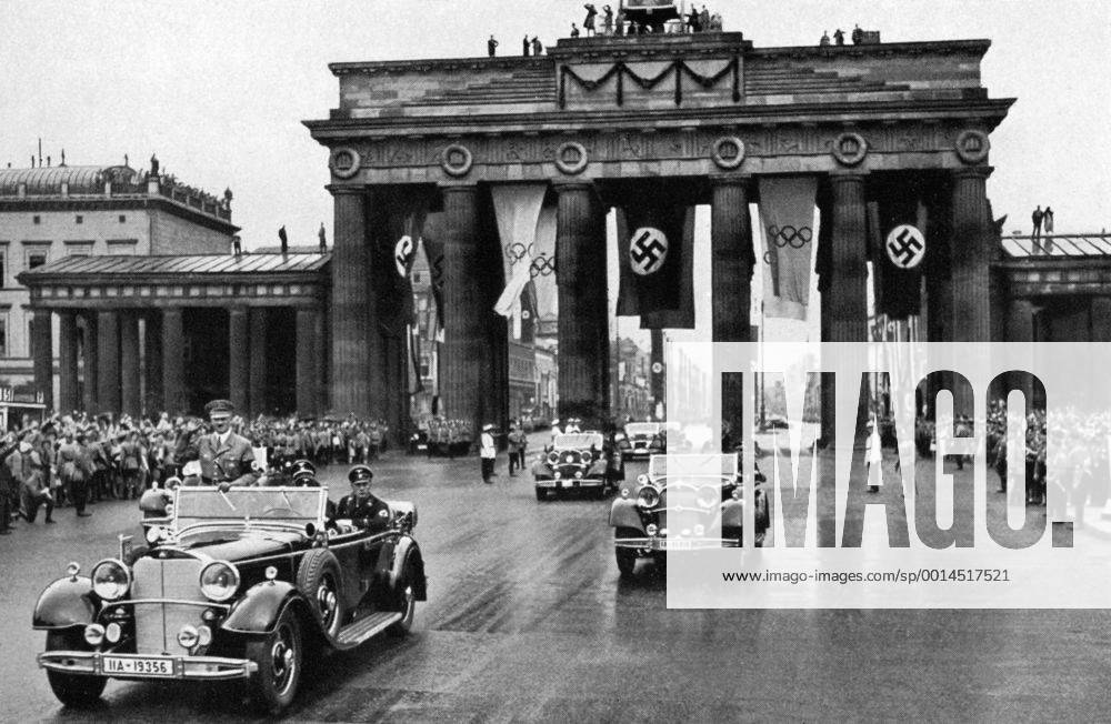1936 Olympics, Berlin - Adolf Hitler in an open top car leading a fleet of cars through the Brandenburg Gate past spectators on its way to the 1936 Olympic Games. (Der Fuhrer Adolf Hitler, schirmherr der Olympischen Spiele, begibt such durch das Spalier der begeisterten Volksmenge zum Reichssportfeld, um die Spiele feierlich zu eroffnen) Â UnitedArchives00834924