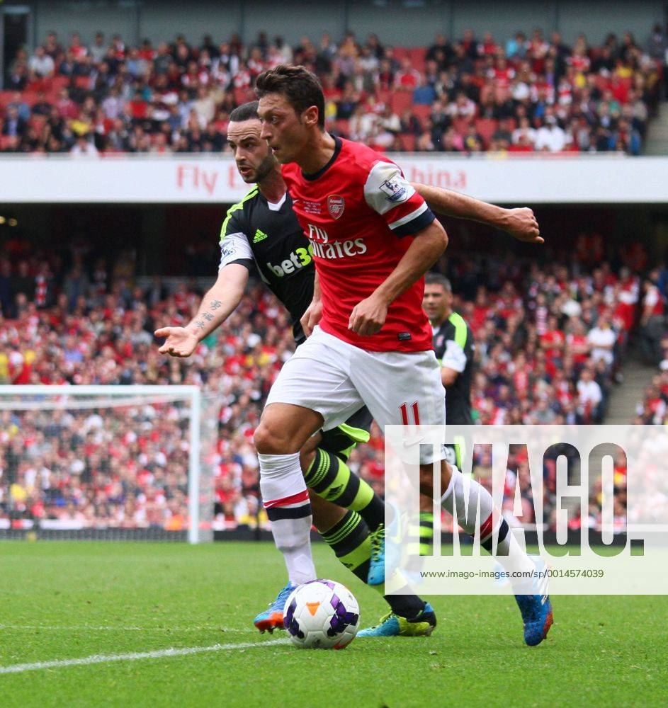 Arsenal v Stoke City . . London, UK . . 22.09.2013 Mesut Ozil (A) Marc Wilson (SC)